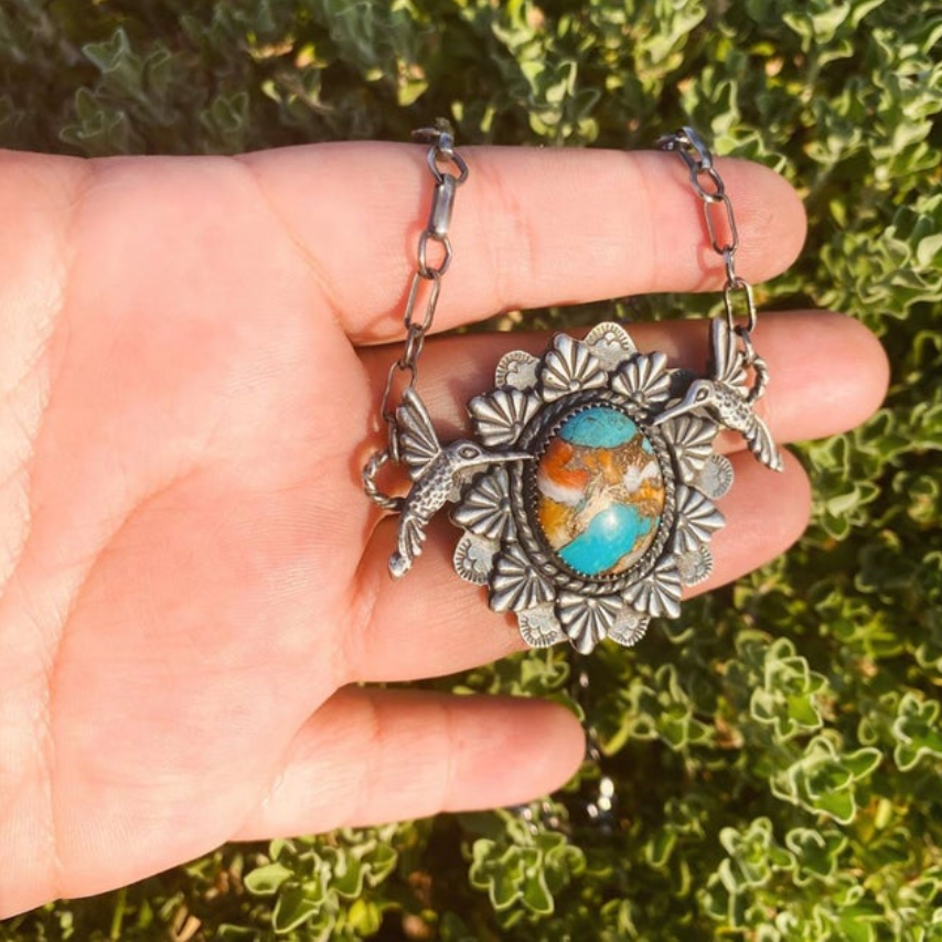 turquoise pendant with silver cast hummingbirds